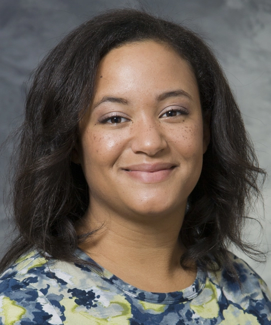 Andrea Gilmore Bykovskyi's bio headshot. Andrea smiles and has long black hair.