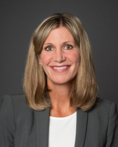 Professional headshot of CHDR Deputy Director Dr. Ann Sheehy against a grey background. 