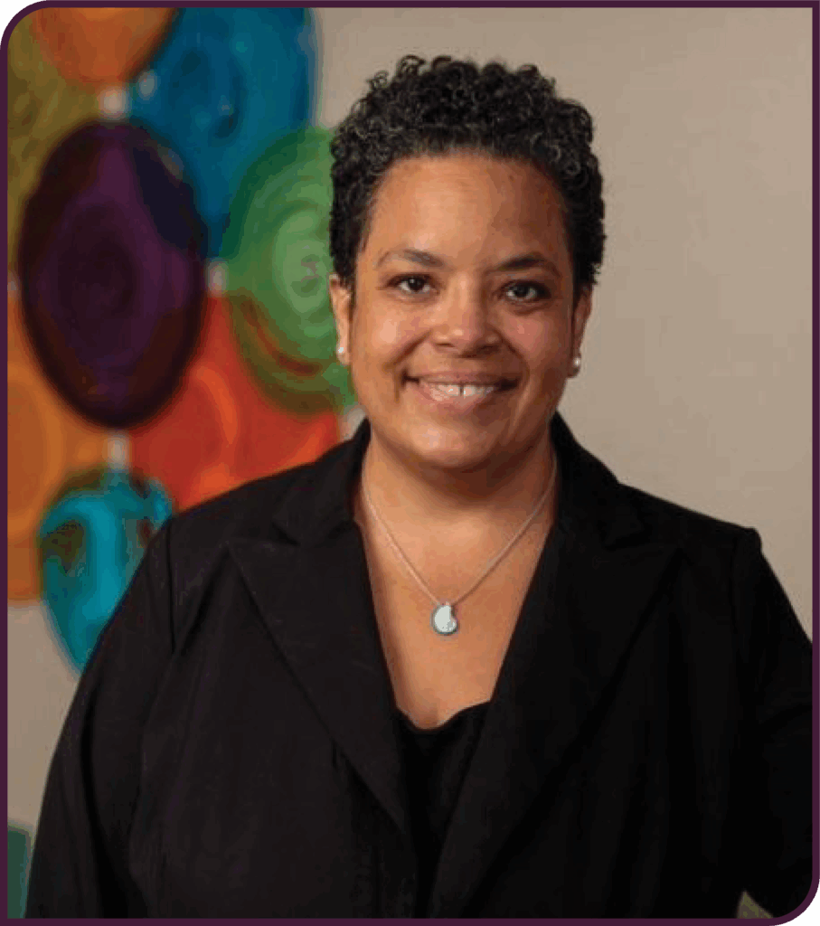 Dr. Felicity Enders wears a lack blazer and smiles in this professional headshot. 